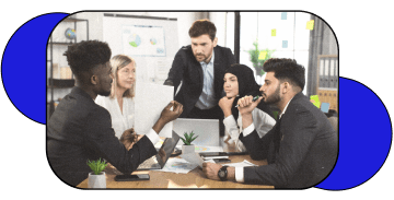 A Group of 5 people in a boardroom discussing a project.
